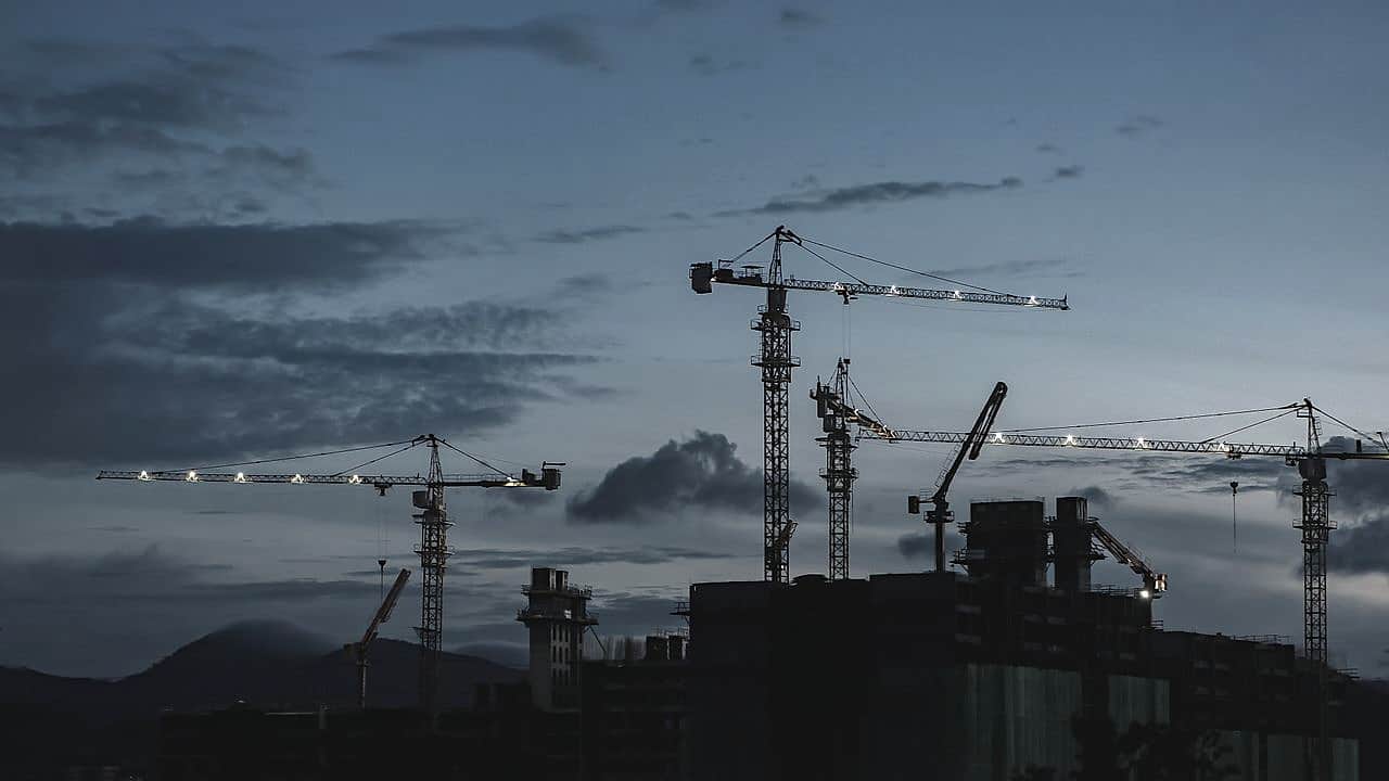 Construction cranes at twilight